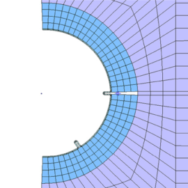 Das Bild zeigt eine technische Darstellung eines Rohrquerschnitts mit einer Netzstruktur zur Analyse. Der Kreis ist teilweise gefüllt und in zwei Farbbereiche unterteilt: ein innerer Bereich in Blau und ein äußerer Bereich in Violett, die unterschiedliche Zonen markieren. Die Darstellung enthält feine Linien, die die Berechnungselemente des Modells anzeigen, sowie zwei kleine Stifte oder Markierungen, die vermutlich Messpunkte oder Befestigungen darstellen. Die Grafik ist auf einem weißen Hintergrund dargestellt und wirkt wie eine Simulation oder ein Finite-Elemente-Modell.